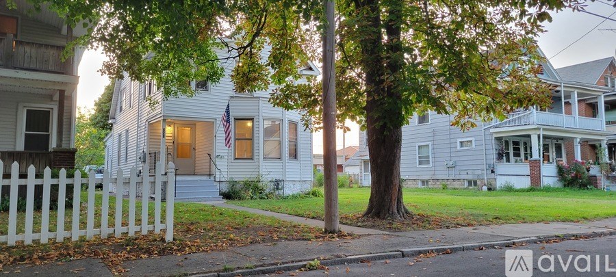 A room with a table and chairs and a ceiling fan.