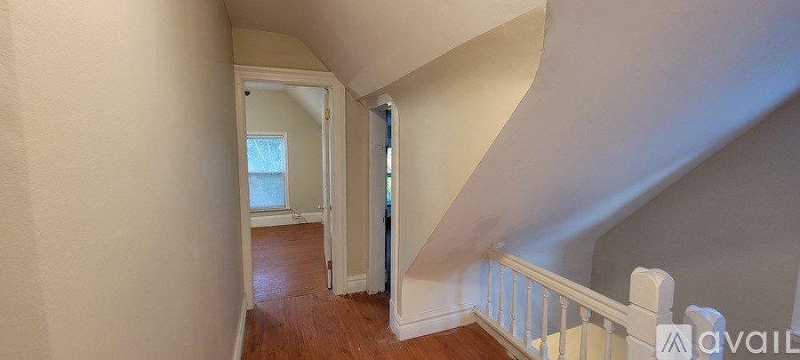 A staircase with a white railing and wooden steps.