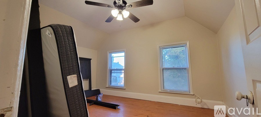 A room with a fan and a window.