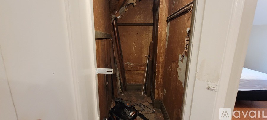 A white bathroom with a black and white floor.