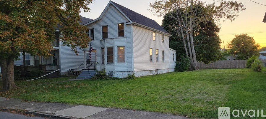 A house with a flag on the front porch is available for rent.
