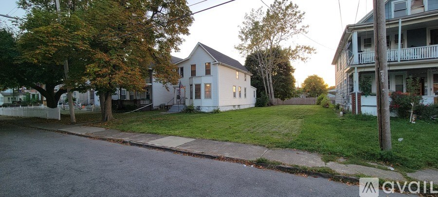 A house with a white facade is available for rent.