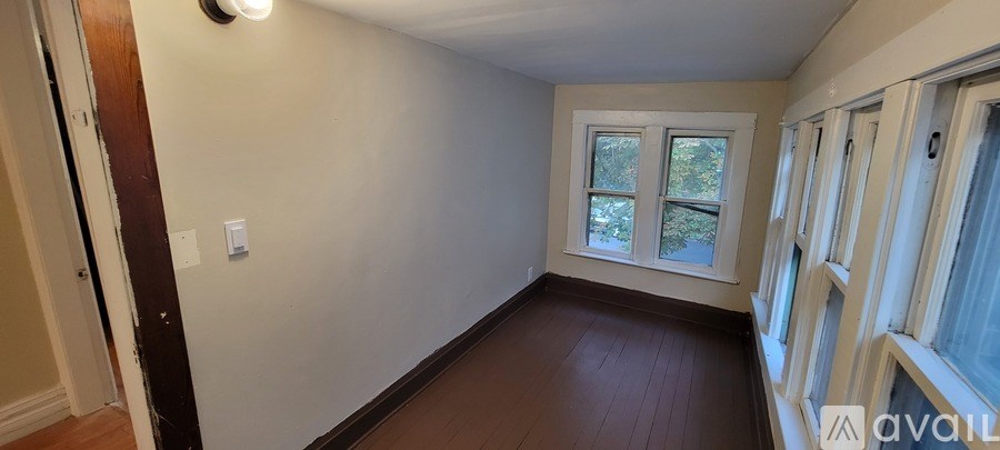 A room with a window and a door.