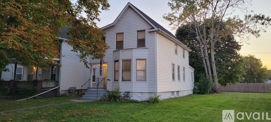 A house with a porch and a flag on it.
