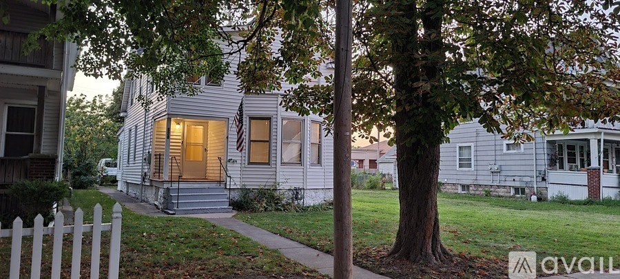 A house with a white picket fence in front of it.