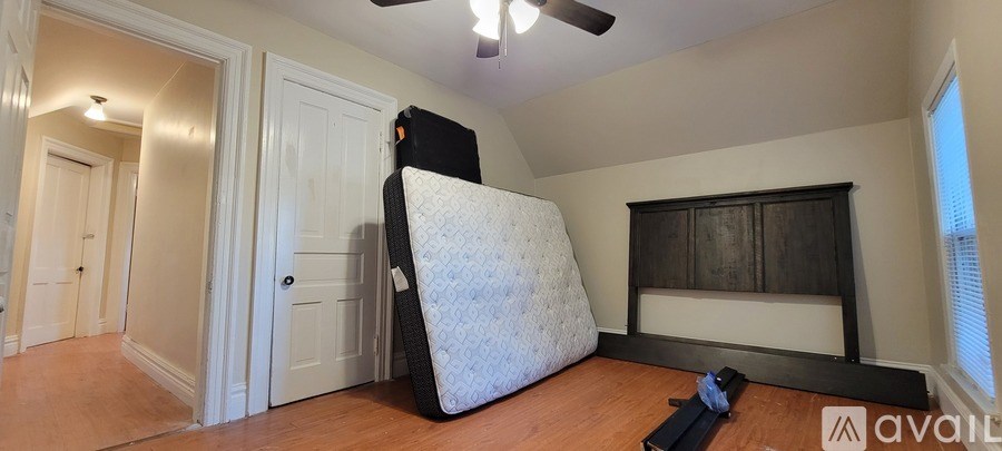 A room with wooden floors and white windows.