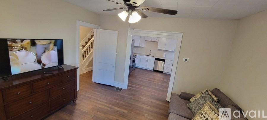 A living room with a television and a couch.