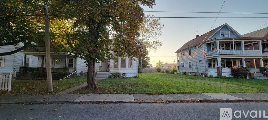 A house with a blue roof is available for sale.