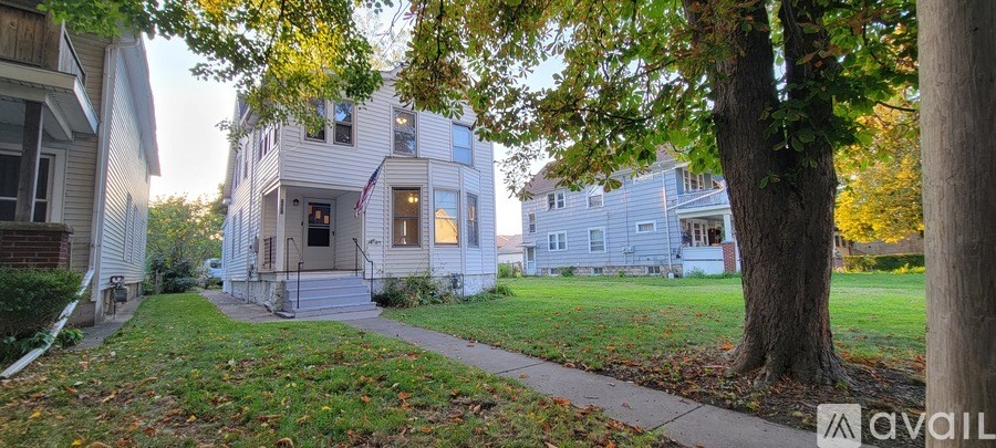 A house with a tree in front of it.
