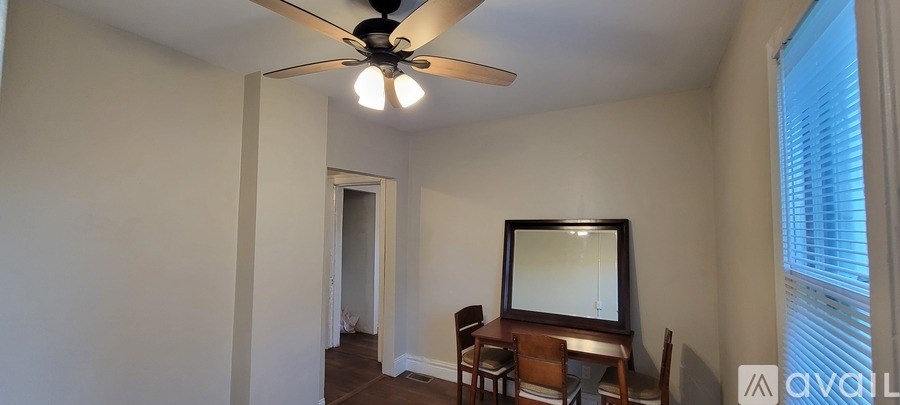 A room with a television and a fan.