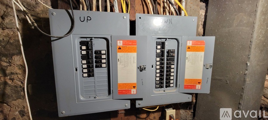 Three electrical boxes are mounted on a wall.