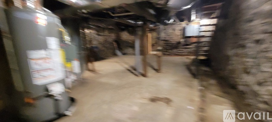 A dirty alley with a fridge on the left.