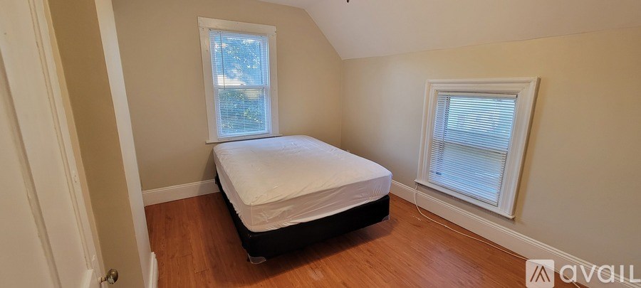 A room with wooden flooring and a ceiling fan.