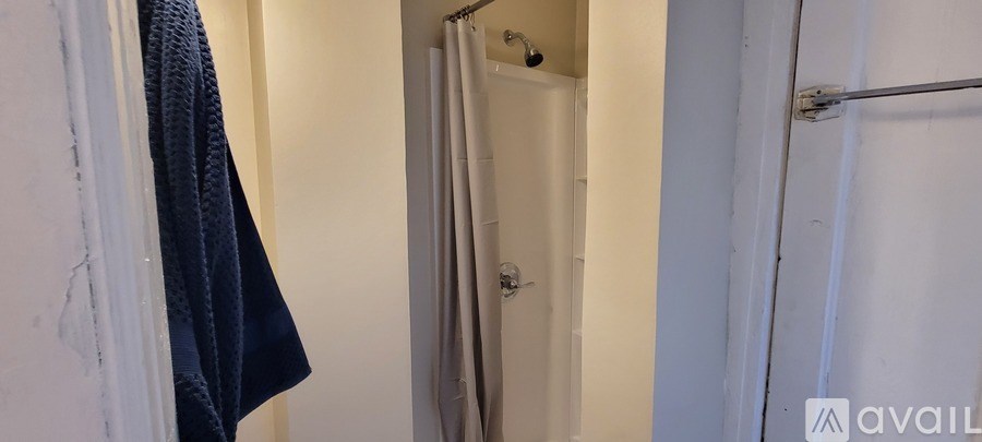 A white door is in a white room.