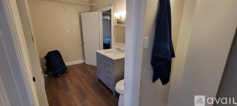 A bathroom with a towel hanging on the wall.