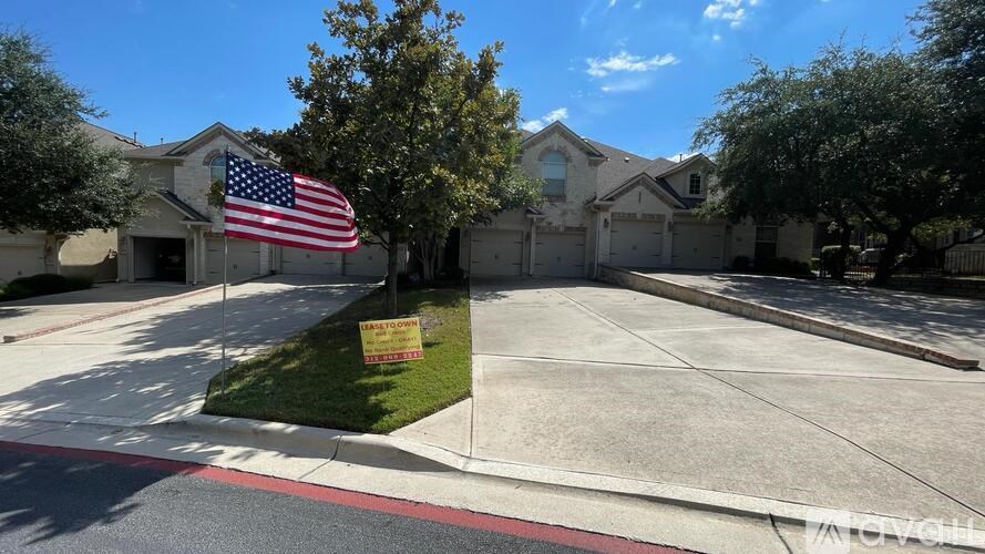 A house with a flag on the lawn.