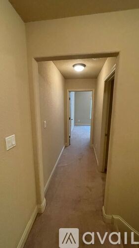 A hallway with a door at the end.