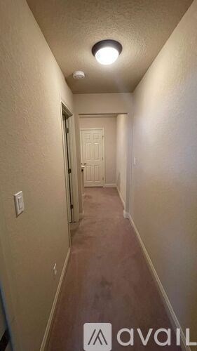 A long hallway with a door at the end.