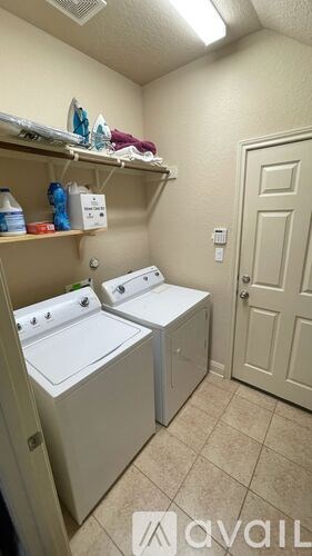 A small laundry room with a washer and dryer.
