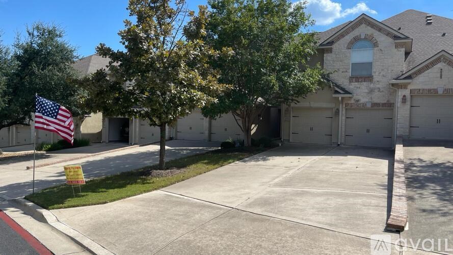 A house with a flag on the lawn.
