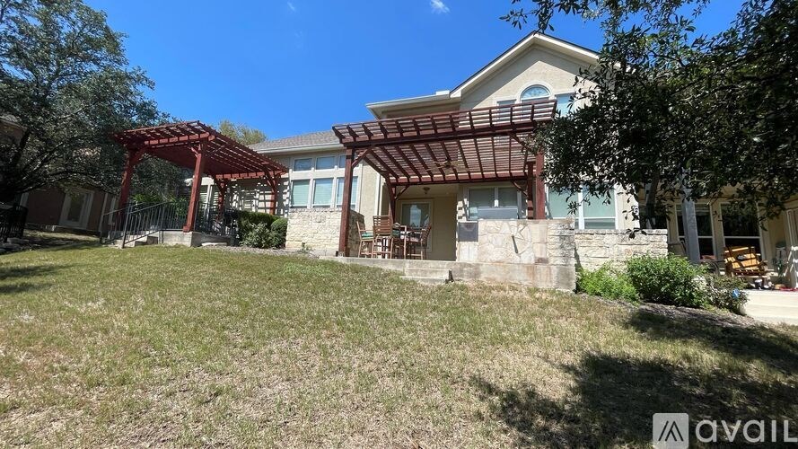 A house with a red pergola is for sale.