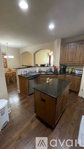 A kitchen with wooden cabinets and a central island.