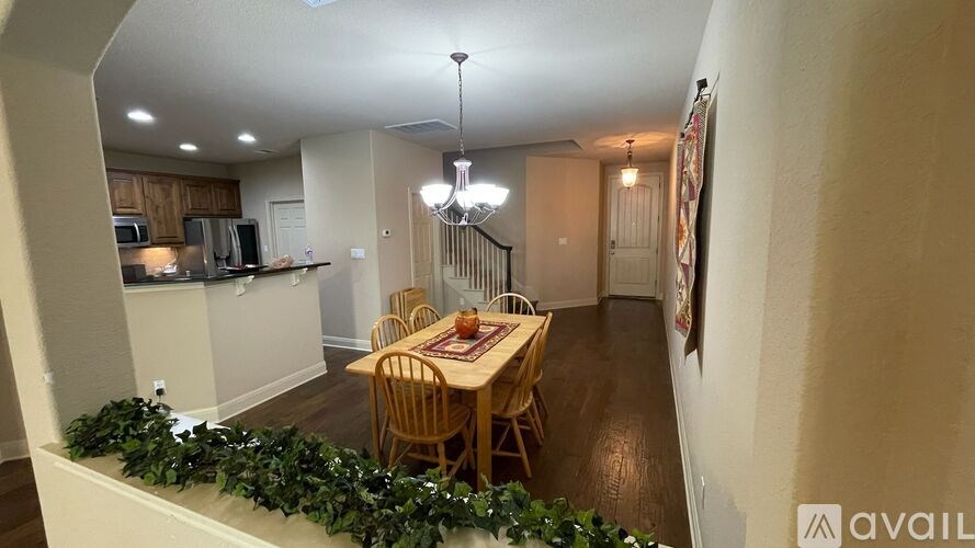 A dining room with a table set for six people.