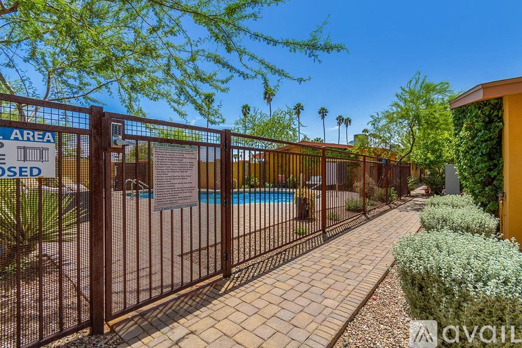A gated area with a sign that says "AVAILABLE" and a pool in the background.