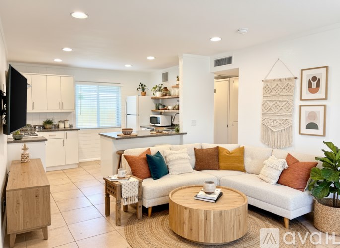 A modern living room with a white sofa and a wooden coffee table.