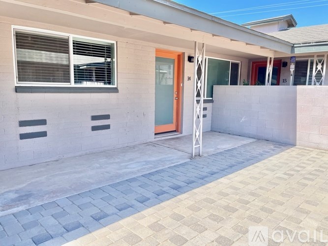 A house with a blue door and windows with blinds.