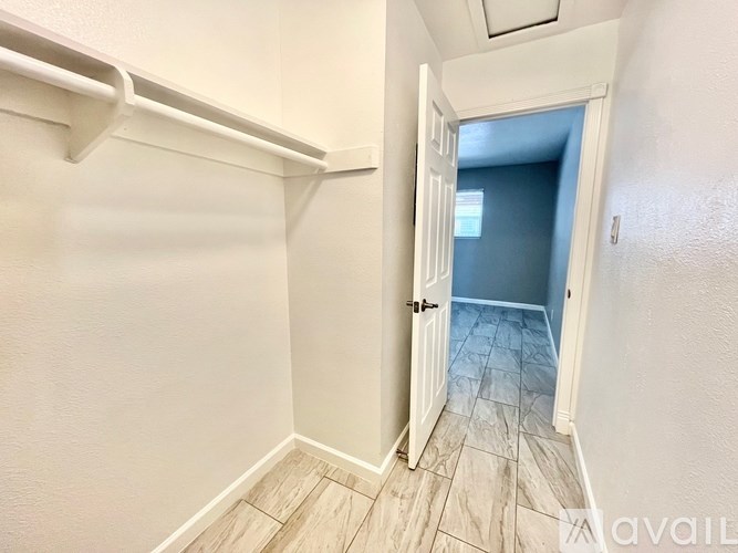 A hallway with a doorway leading to another room.