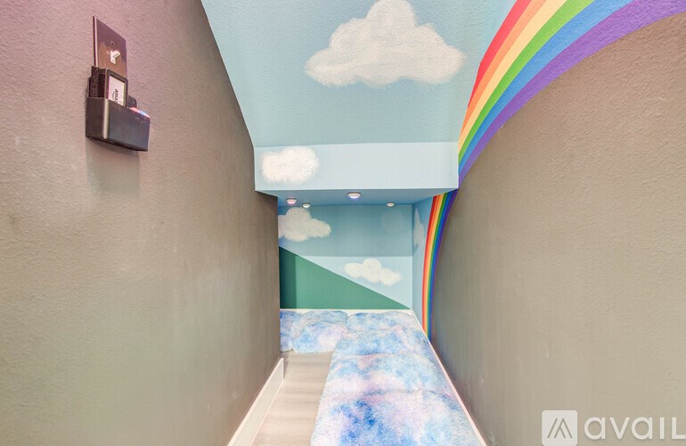 A hallway with a rainbow painted on the ceiling.