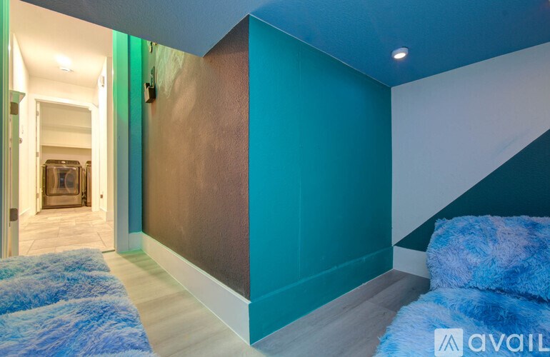 A hallway with a blue carpet and a brown wall.