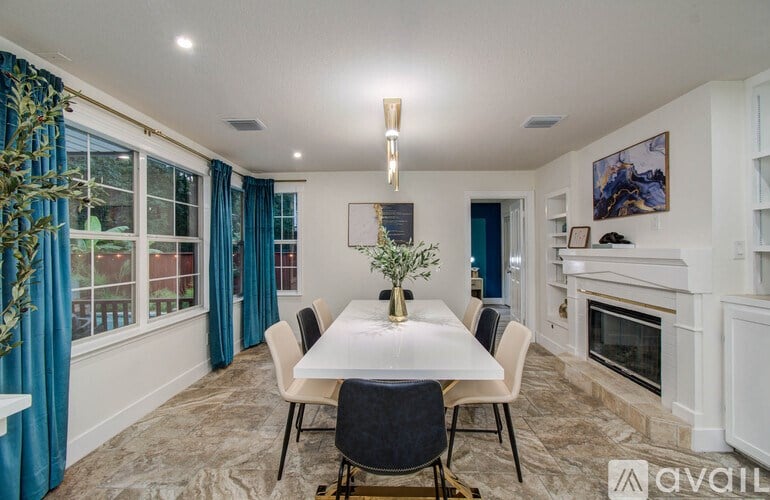 A dining room with a table set for four.