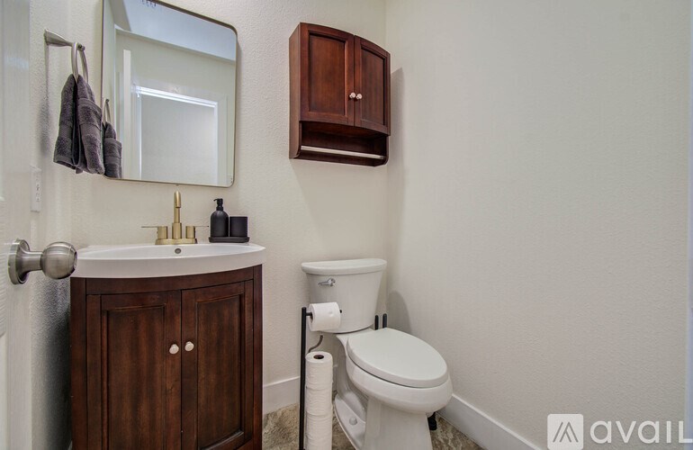 A white toilet sits next to a sink in a bathroom.