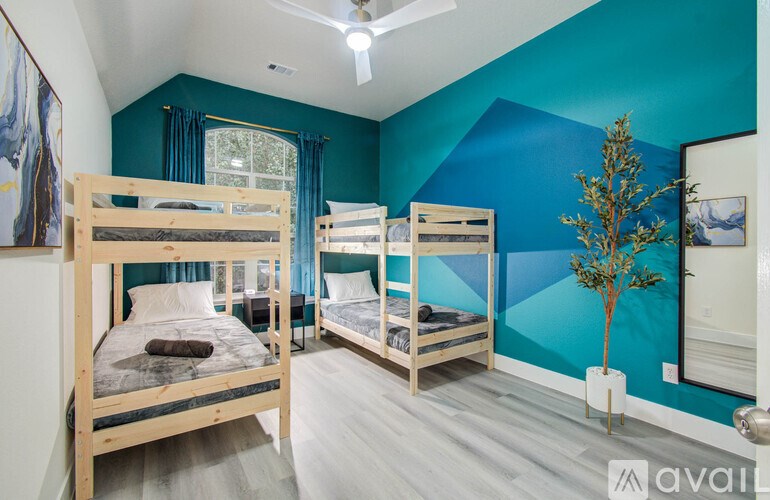 A room with bunk beds and a ceiling fan.