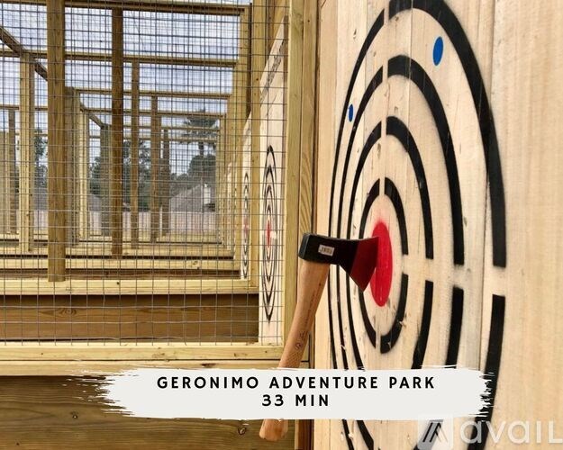 A sign for Geronimo Adventure Park is displayed with a target and a hammer.
