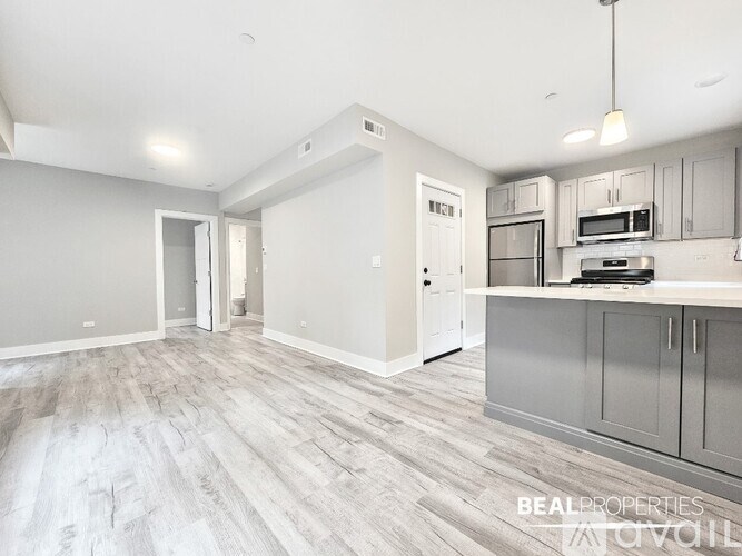 A kitchen with a white countertop and grey cabinets.