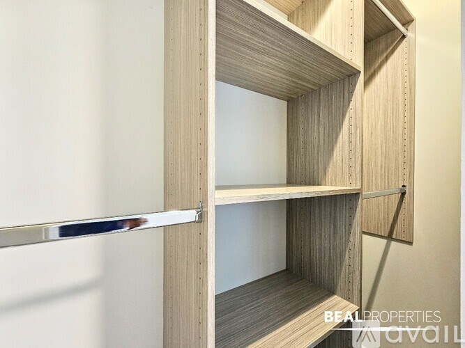 Empty shelves in a room with a white wall.