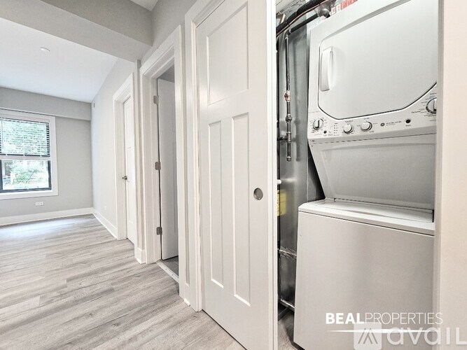 A modern kitchen with a white oven and wooden flooring.