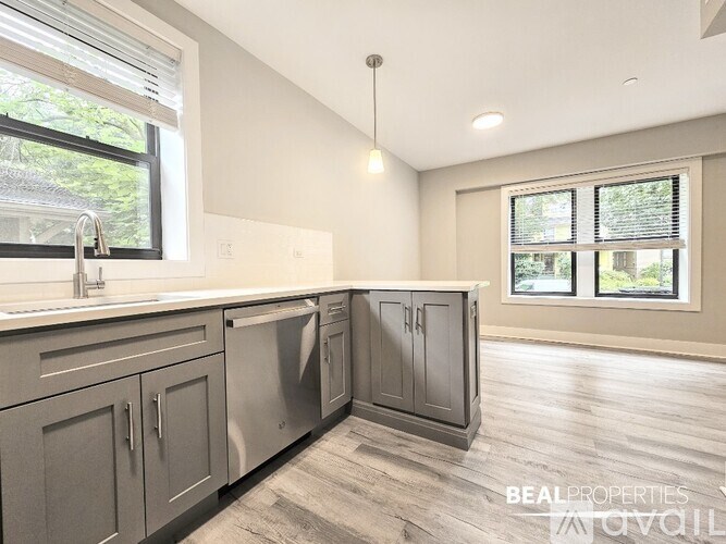 A modern kitchen with a large island and stainless steel appliances.