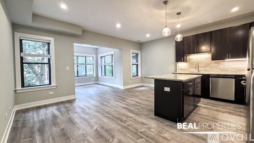 A spacious kitchen with dark wood cabinets and a central island.