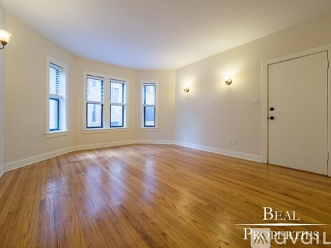 A room with wooden floors and a white door.
