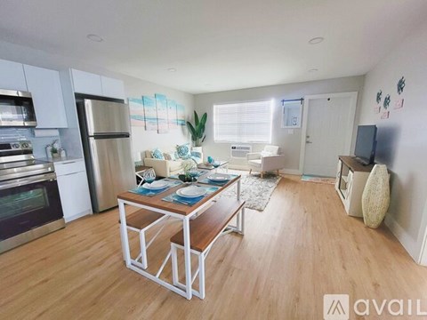 A kitchen with a table and chairs in the middle of the room.