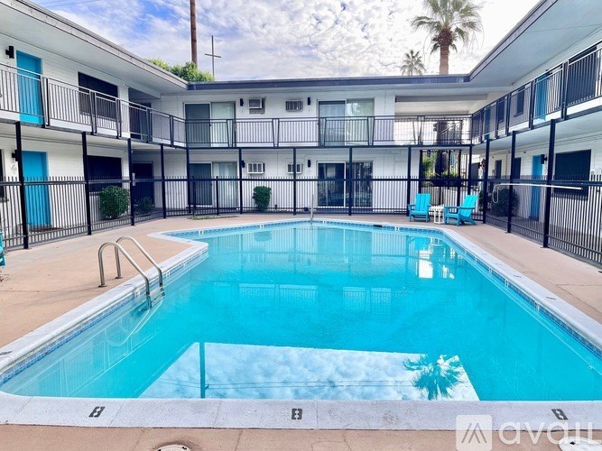 A pool in a courtyard surrounded by apartment buildings.