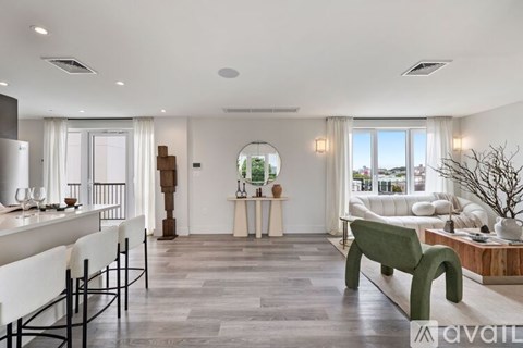 A modern living room with a green bench and a dining table with chairs.