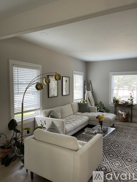 A living room with a white sofa and a coffee table.