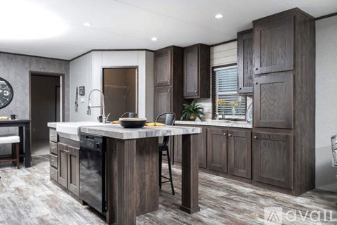 A modern kitchen with dark wood cabinets and a marble countertop.