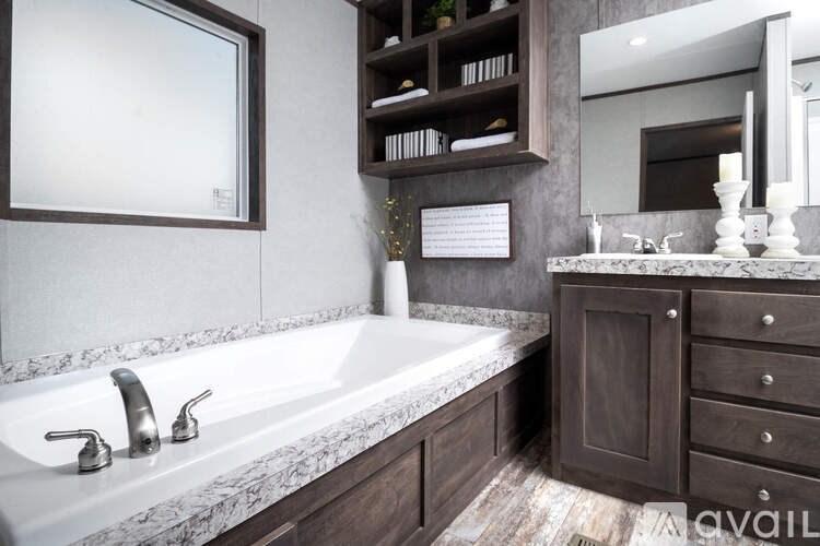 A bathroom with a marble countertop and a white sink.