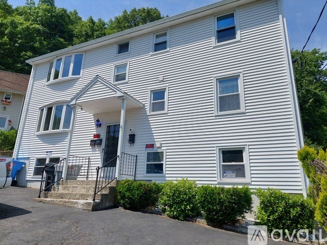 A white house with a black door and windows.